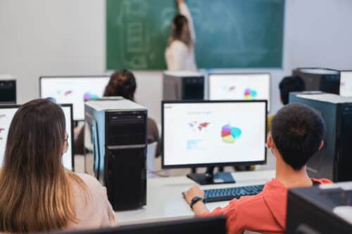 students in classroom using technology