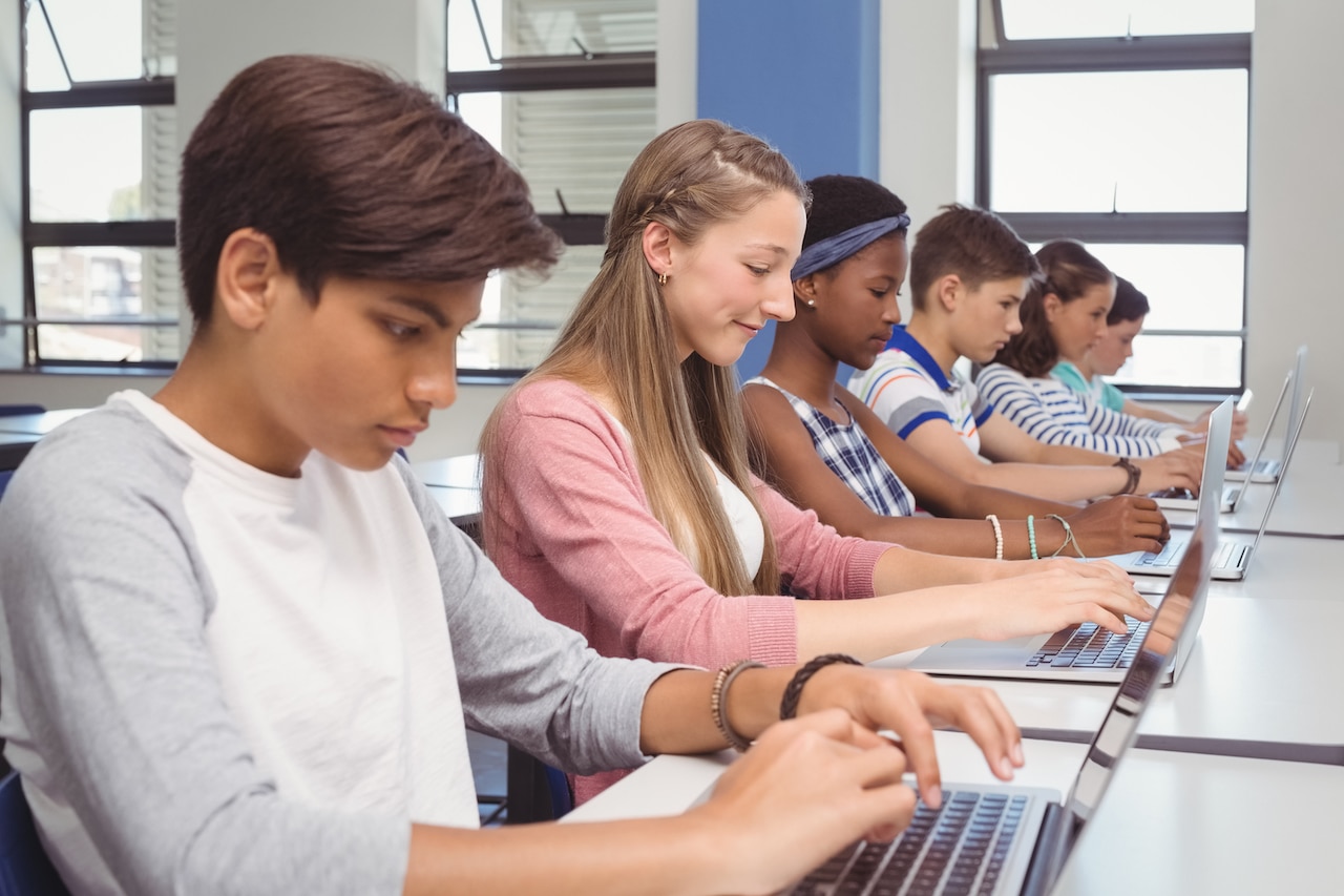Students using laptops in classroom and are saving school work to avoid data disaster